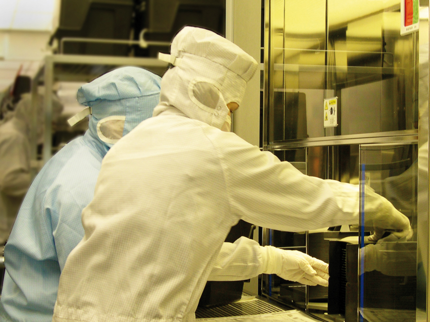 Photo of two employees in the CMOS clean room