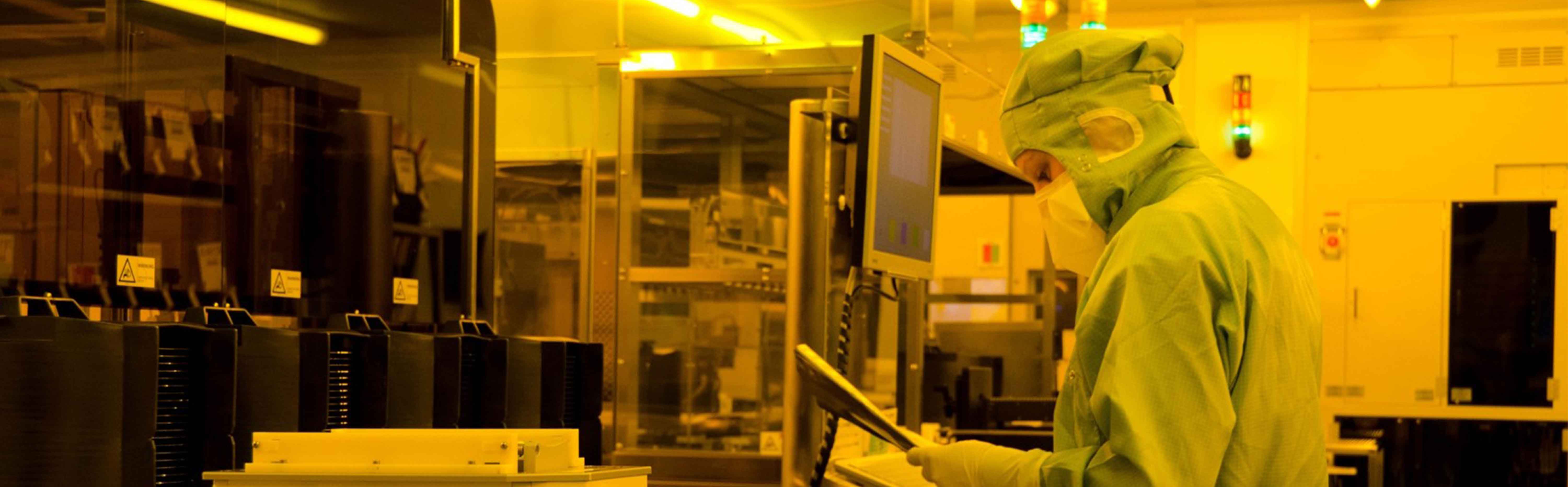 Picture of a person in a clean room of Fraunhofer IMS